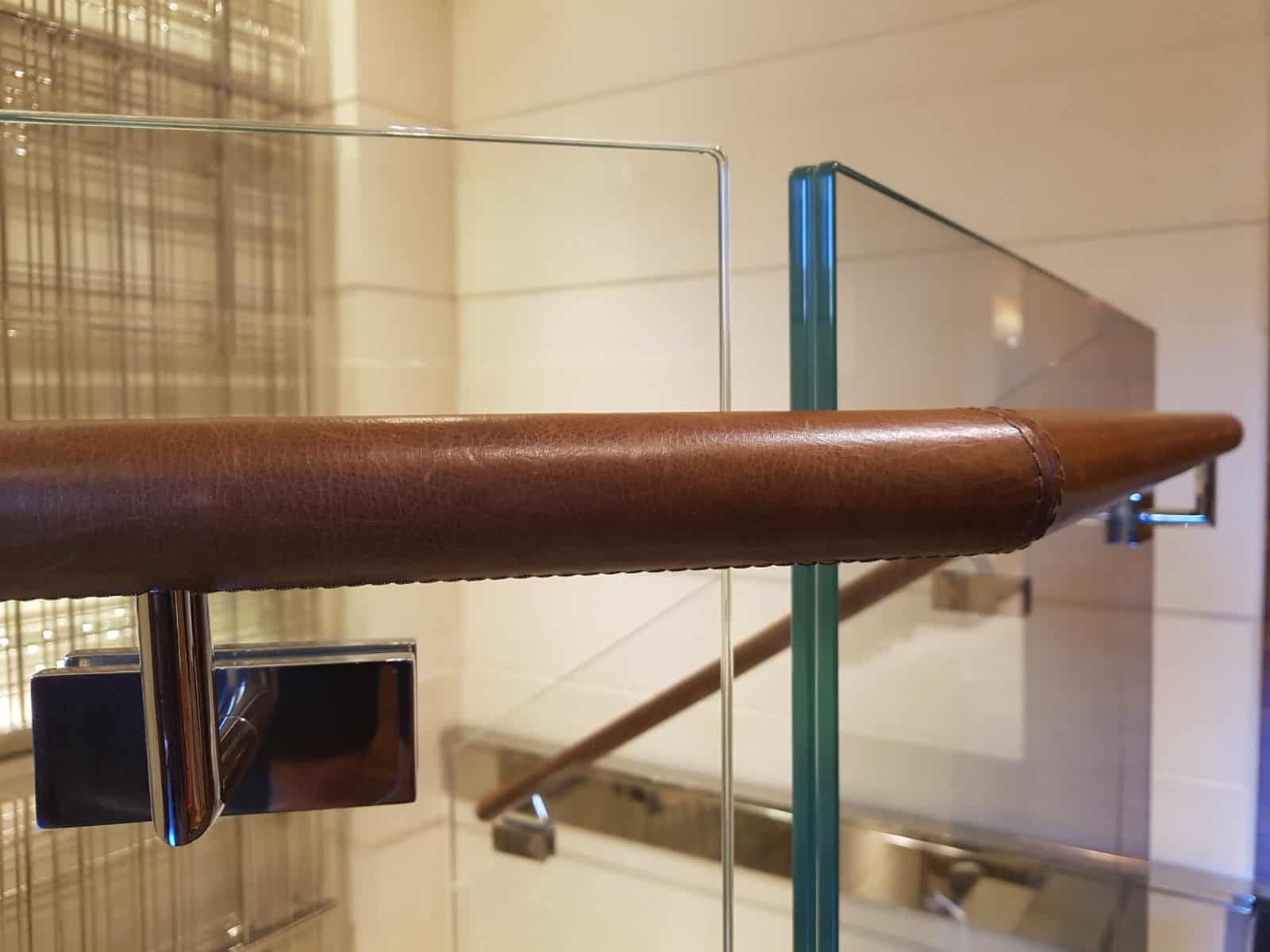 leather wrapped handrails next to frameless glass balustrade