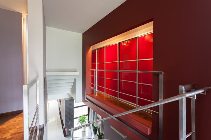 stainless steel balustrade next to red wall